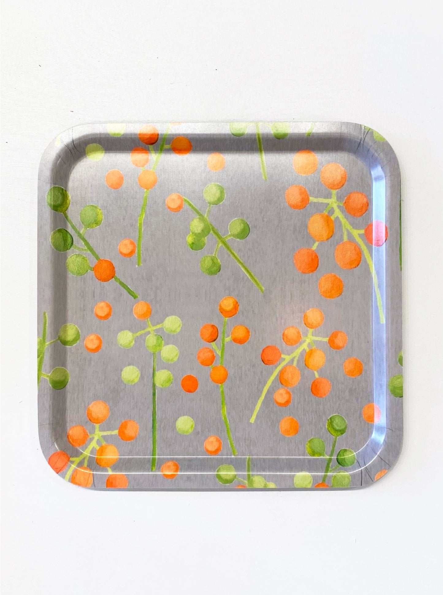 Serving tray featuring orange and green berries melamine and birch veneer